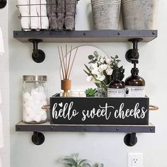 a shelf with some bottles and candles on it in a bathroom next to a toilet