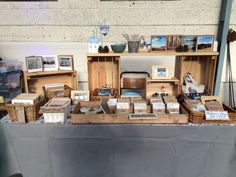 a table that has some books on top of it with pictures and other items behind it