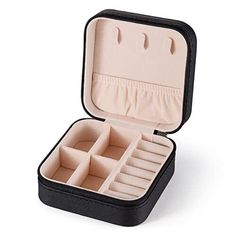 an open black case filled with compartments for jewelry