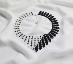 Unique White Choker Necklace, Unique White Necklaces For Party, Unique White Necklace For Party, Unique White Jewelry With Black Beads, Handmade White Crystal Choker Necklace, Elegant Handmade Black And White Jewelry, White Handmade Necklaces For Parties, Unique White Beaded Choker Necklace, Handmade White Necklaces For Party