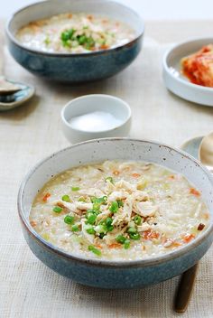 two bowls filled with soup on top of a table