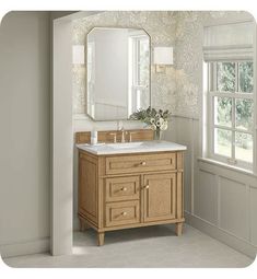 a bathroom vanity with a large mirror above it and a vase on the counter next to it