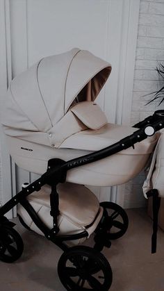 a baby stroller with a white cover on it