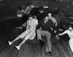 an old black and white photo of people dancing