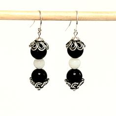 "- Black Agate and White Quartz Beaded Gemstone Earrings in Polished Beads pair with Antique 925 Sterling Silver Floral Bead End Caps in this stunning Earring. See Photos #1-2. - Black Agate is in 8mm Beads and White Quartz is 6mm Beads. - See Matching Necklace, 2 Stretch Beaded Bracelets and Jewelry Set called \"Black and White Ball\". This Earring may be substituted for the all Black Agate Earring shown in the Set. See Photo #3-4, 7-9. - 925 Sterling Silver Filled Bali Hook Ear Wire with Ball Elegant Agate Gemstone Bead Earrings, Elegant Earrings With Gemstone Beads, Silver Beaded Earrings With Natural Stones, Sterling Silver Gemstone Bead Earrings, Silver Earrings With Gemstone Round Beads, Silver Earrings With Gemstone Beads, Sterling Silver Earrings With Round Gemstone Beads, Elegant Adjustable Beaded Earrings With Gemstone Beads, Elegant Beaded Agate Earrings