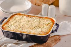 a casserole dish with cheese and parmesan