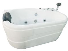 a large white bath tub sitting on top of a white floor next to a faucet