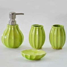 a green bathroom set with soap dispenser, toothbrush holder and soap dish