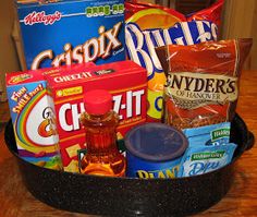 an assortment of snacks and condiments in a black bowl on a wooden table