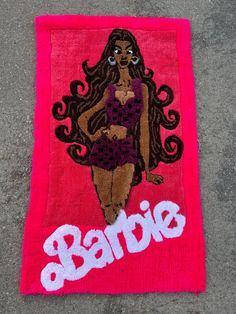 a towel with a woman's image on it and the word barbie written in white