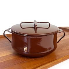 a brown casserole sitting on top of a wooden cutting board