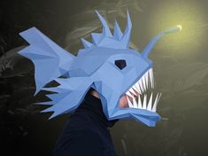 Blue anglerfish mask against a dark background full of fish Angler Fish Costume, Scary Halloween Mask, Fish Diy, Halloween Maske, Deep Sea Fish, Fish Mask, Scary Halloween Masks, Fish Costume