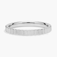 This stackable ring features vertical angled mirrored edges along its outer edge, giving it a bold contemporary style. It features gleaming 18k white gold design for a look of cool luxury. Modern Bands With Polished Edges, Modern Silver Stackable Bands, Modern Stackable White Gold Rings, Modern Stackable Silver Bands, Modern White Gold Rings With Shiny Finish, Modern White Gold Bands With Polished Finish, Modern White Gold Band With Polished Finish, Modern Polished White Gold Band, Modern Silver Stackable Diamond Cut Rings