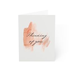 a card with the words thinking of you written in black ink on top of it