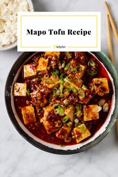 a bowl filled with tofu and rice next to chopsticks on a table