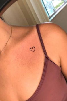 a woman with a heart tattoo on her chest