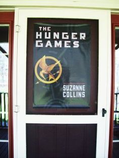 a sign on the front door of a building that says, the hunger games suzanne collins