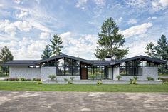 the modern house is surrounded by trees and grass