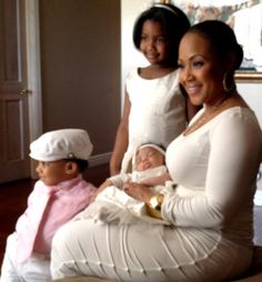 two women and a baby are sitting on the floor