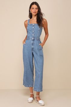 The Levi's Drea Medium Wash Button-Front Sleeveless Denim Jumpsuit is the one-and-done option for a totally coveted look! Sturdy cotton denim (in Levi's Cause and Effect wash) shapes wide, adjustable tank straps (with internal button closures at the back) and a straight neckline. The seamed bodice has a functional silver button placket that meets the high waist with belt loops. Loose-fitting, straight pant legs feature a hidden zip fly, diagonal front pockets, back patch pockets, and ankle-length hems. Smocking at back for fit. Classic red logo tag at back. Fit: This garment fits true to size. Length: Ankle length. Bust: Great for any cup size. Waist: Fitted - very fitted at natural waist. Hip: Loosely Fitted. Undergarments: May be worn with a strapless bra, adhesive bra, petals, or no bra Concert Outfit Casual, Wineries Outfit, Casual Formal Dresses, Jumpsuit Blue, Lulu Fashion, Casual Wedding Dress, Adhesive Bra, Straight Neckline, Cause And Effect