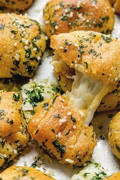 cheesy garlic knots stuffed with mozzarella cheese on a white platter