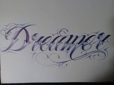 the word dream written in cursive writing on a piece of paper