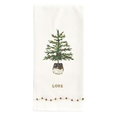 a tea towel with a christmas tree in a pot on it and the words love