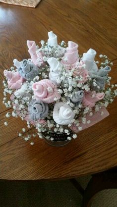 a vase filled with baby's breath flowers on top of a wooden table