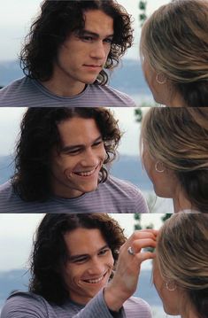 the man is smiling while he has his hair pulled back into a ponytail and smiles at another woman's face