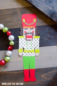 a paper cut out of a nutcracker with decorations around it