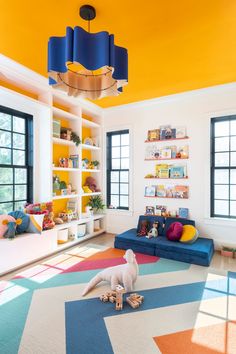 a brightly colored living room with an animal toy on the floor