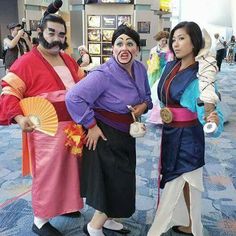 three people dressed in costumes posing for the camera