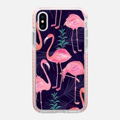 an iphone case with pink flamingos and palm leaves on a dark blue background,