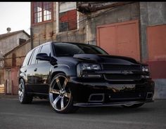 a black car parked in front of a building