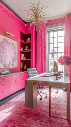 the pink room is decorated with gold accents and furniture, including a chandelier