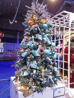 a christmas tree with ornaments on display in a building