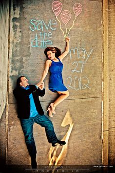 a man and woman leaning against a wall with balloons written on it