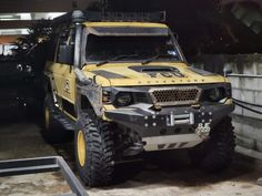 a yellow and black truck parked in a garage