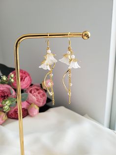 These elegant bell flower earrings are made with glass beads and 925 sterling silver. The dangle length is around 7cm/2.7". Each pair is lovingly handmade! 🎀 CARE INSTRUCTIONS 🎀 * Avoid getting your jewelry wet * Avoid perfumes or sprays * Store in a cool, dry place Dainty White Chandelier Earrings For Gift, Dainty White Chandelier Earrings As Gift, White Flower Earrings With Dangling Beads For Gift, Elegant Flower Earrings With Dangling Beads, Elegant Flower Earrings With Dangling Beads For Gift, Elegant Adjustable Flower Earrings With Dangling Beads, Luxury Handmade Dangle Flower Earrings, Elegant Clip-on Dangle Flower Earrings, Elegant Flower-shaped Earrings With Dangling Beads