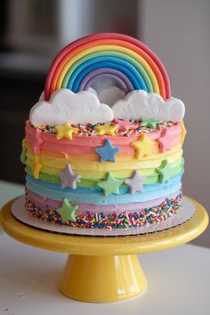 a rainbow cake with sprinkles and stars on it