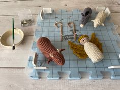 crocheted toys are displayed on a tray