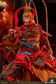 the action figure is dressed in red and gold, with an elaborate headdress