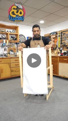 a man holding up a white sign in a shop