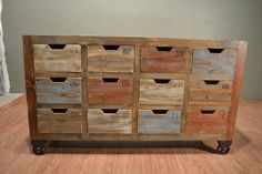 an old wooden dresser with drawers and numbers on the top drawer, sitting on a hard wood floor