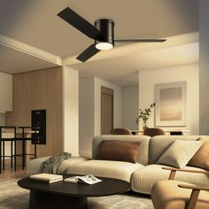 a living room filled with furniture and a ceiling fan