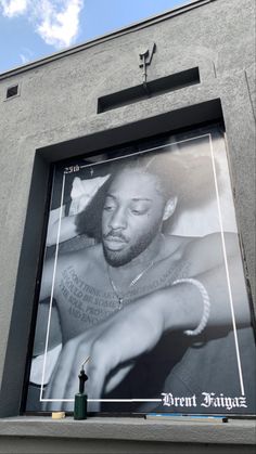 a large billboard on the side of a building with a black and white photo of a man