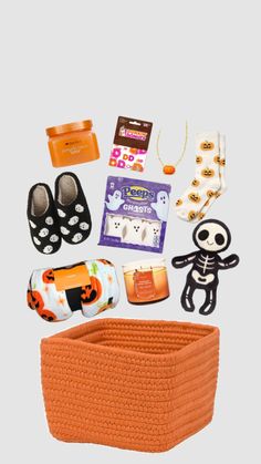 an assortment of halloween items including shoes, socks and other things to put in a basket