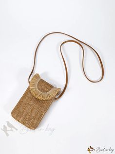 a straw bag is shown on a white surface with a brown cord around the strap