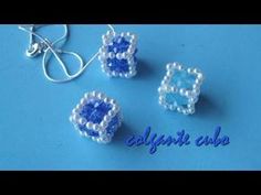 three beaded earrings with blue and white beads on the bottom, one is made out of