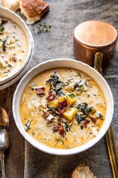 two bowls of soup with bread on the side